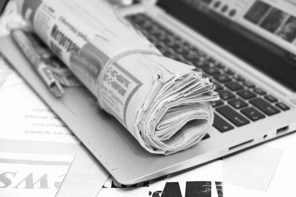 istock Newspapers and Laptop 1194452540