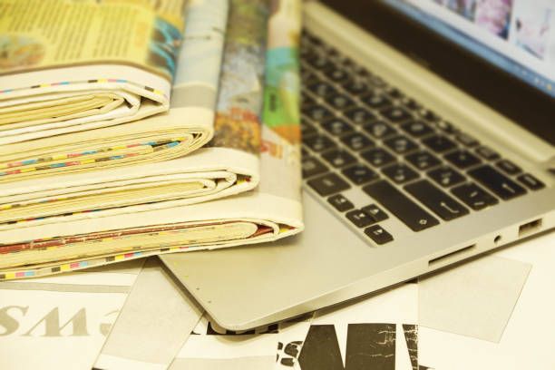 istock Newspapers and Laptop 1194452571