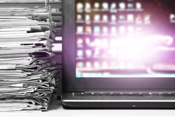 istock Newspapers and Laptop 1194452843