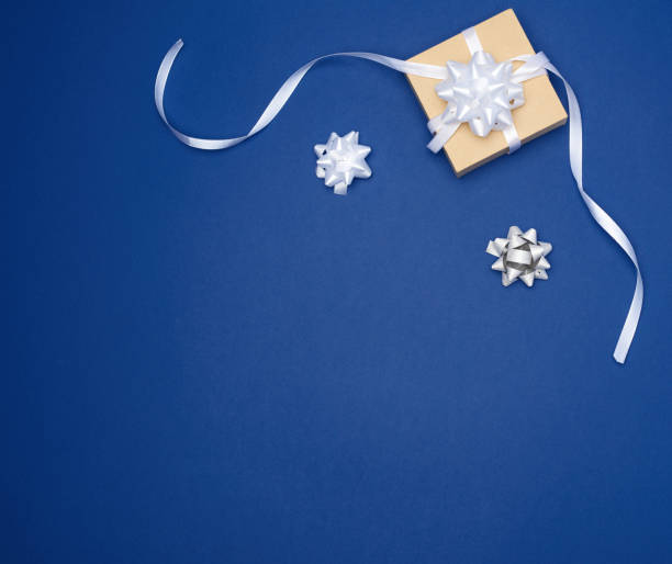 istock brown square box with a gift tied with a white ribbon with a bow 1194454095