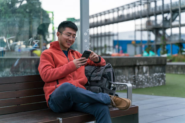 istock young Asian male Checking Social Media 1194454869