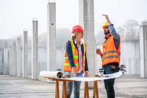 istock Focused Project Team Meeting at Construction Site 1194454905