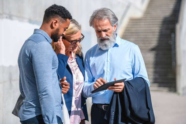 istock Business Associates Checking Digital Tablet Outdoors 1194455103