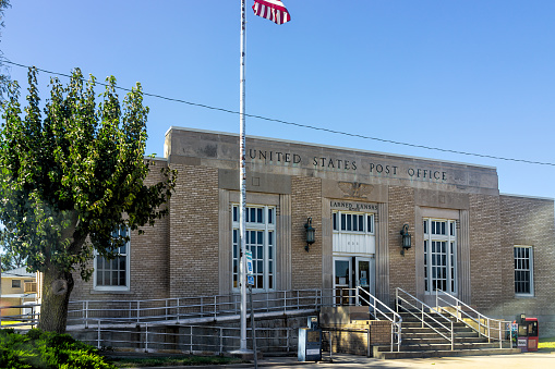 Larned, USA - October 14, 2019: Small town city in Kansas with exterior of building for USPS United States Post Office