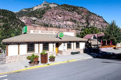 Ouray, USA - September 13, 2019: Small town in Colorado with city main street and wide angle view of red mountain brewing beer store shop tasting business