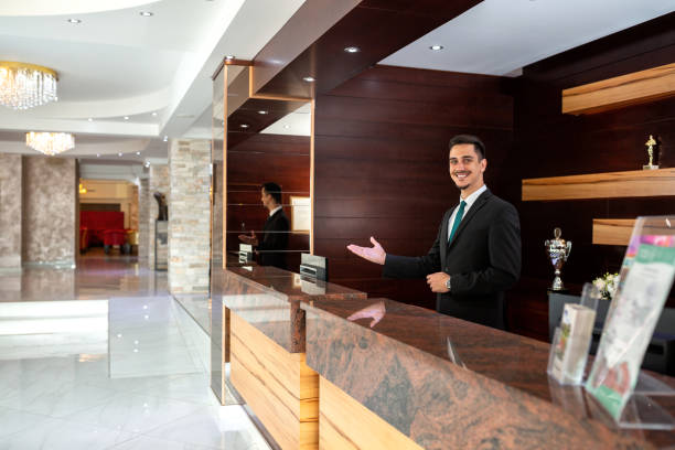 istock Receptionist welcoming guests to a hotel 1194457413