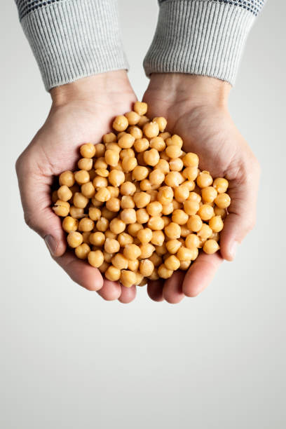 istock man with cooked chickpeas in his hands 1194457468