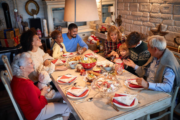 istock Friends and families sitting at a Christmas table 1194458556