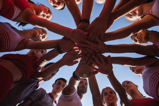 istock Athletics team putting hands together as one 1194459587