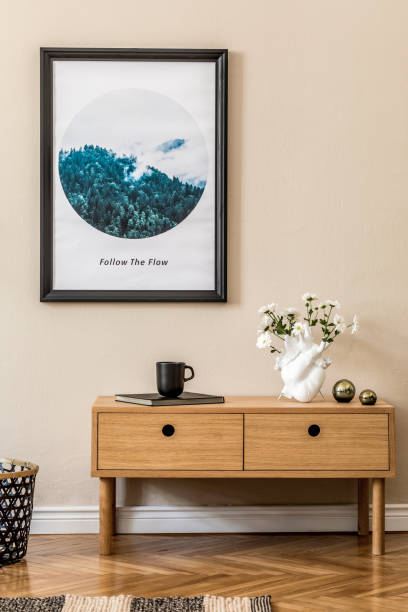 istock Modern scandinavian living room interior with black mock up poster frame, design commode, plant, tea pot, black rattan basket, book and elegant accessories. Template. Stylish home staging. 1194459675