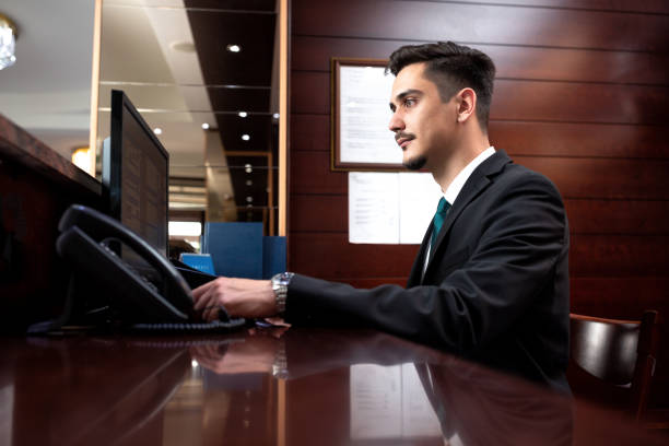 istock Hotel receptionist upholding his responsibilities and managing guests 1194462082