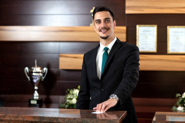 istock Hotel receptionist offering a key card 1194462874