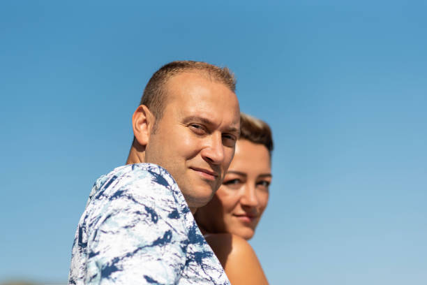 istock couple looking on blue background 1194463483