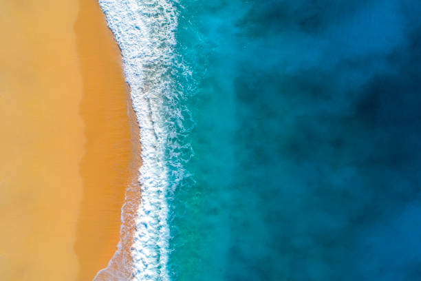Aerial view of clear turquoise sea and waves Waves and and sandy beach of Kaputaş. waters edge photos stock pictures, royalty-free photos & images