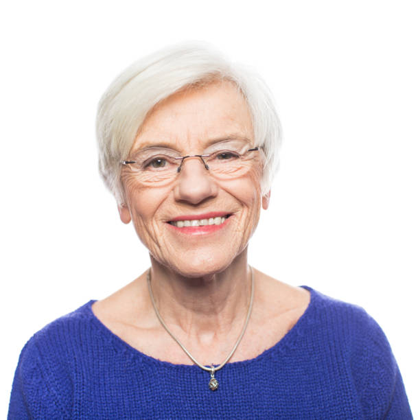 istock Senior woman smiling against white background 1194465599