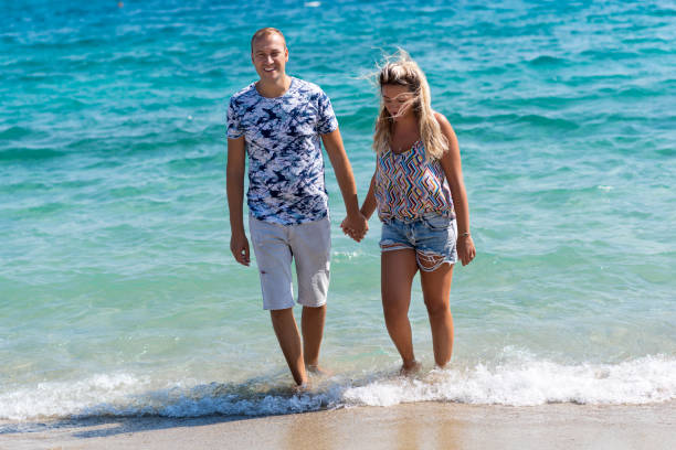 istock Couple holding hands at the beach 1194468790