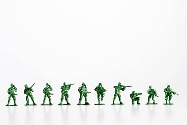 Plastic toy soldiers are standing in a row on a white background Plastic toy soldiers are standing in a row on a white background, ready for battle. toy soldier stock pictures, royalty-free photos & images