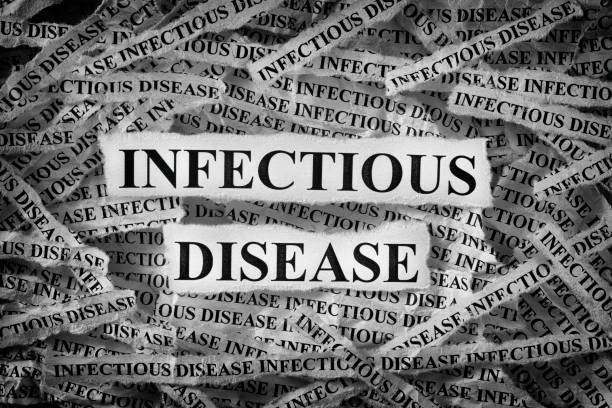 istock Torn pieces of paper with the words Infectious disease 1194472105