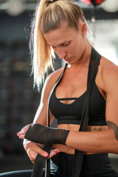 istock Wrapping bandage around hands before putting boxing gloves on 1194475991