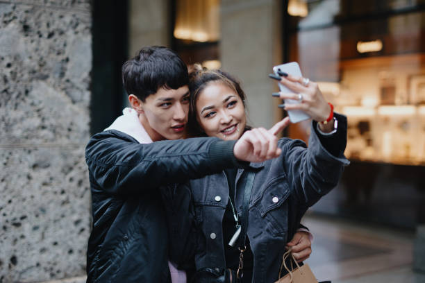istock Happy couple video chatting with friends 1194477923