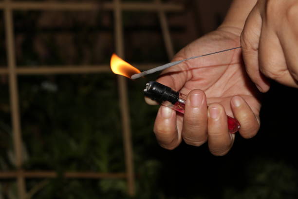 istock Light a small firework to celebrate the new year at night with a lighter 1194481578