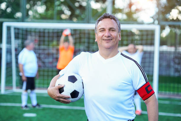 istock soccer player looking at the camera in middle plane with ball 1194483351