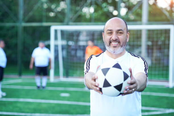 istock soccer player looking at the camera in middle plane with ball 1194483718