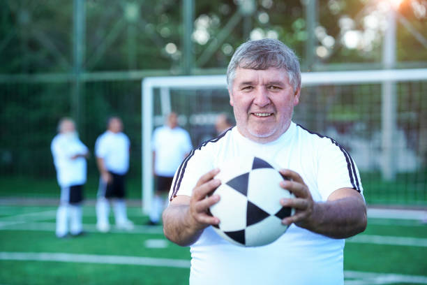 istock soccer player looking at the camera in middle plane with ball 1194483800