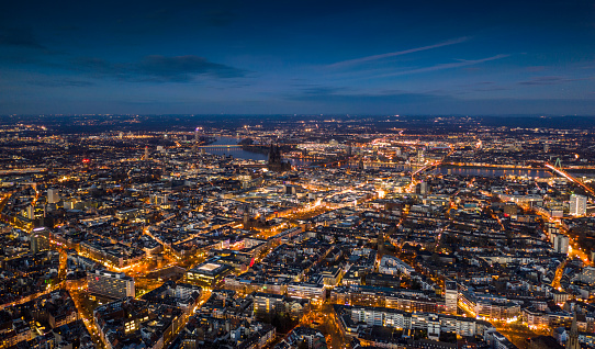 Aerial view of Cologne cityscape illuminated at dusk. Germany - Europe