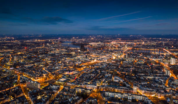 Cologne Cityscape at Dusk Aerial view of Cologne cityscape illuminated at dusk. Germany - Europe cologne photos stock pictures, royalty-free photos & images