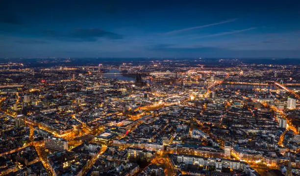 Aerial view of Cologne cityscape illuminated at dusk. Germany - Europe