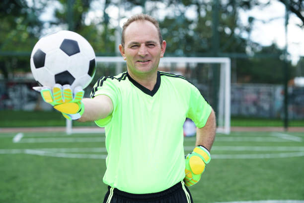 istock soccer player looking at the camera in middle plane with ball 1194484613