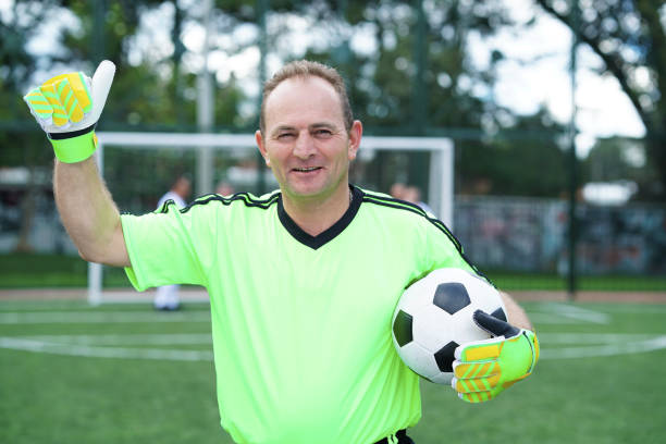 istock soccer player looking at the camera in middle plane with ball 1194484673