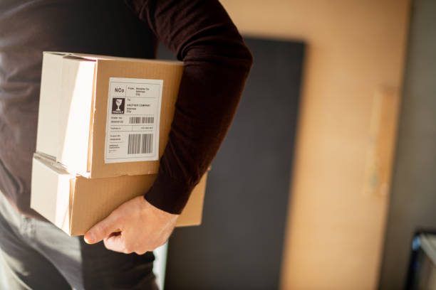 istock Young man carrying packages for shipment 1194484952