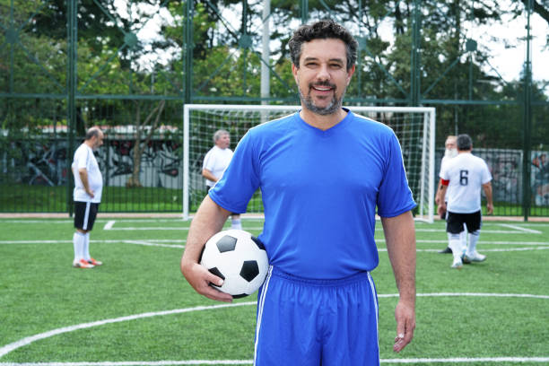 istock soccer player looking at the camera in middle plane with ball 1194484972