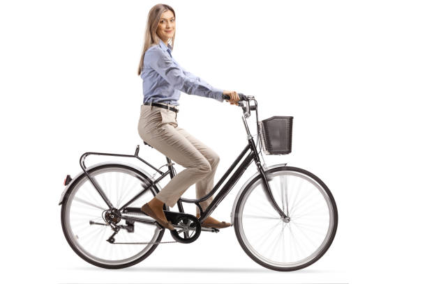 istock Young woman riding a bicycle and looking at the camera 1194486387