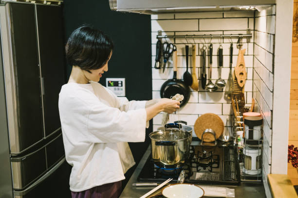 istock Asian Woman cooking in the kitchen 1194487533