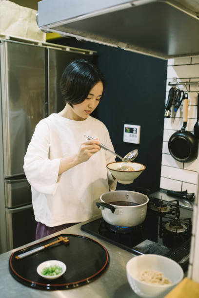 istock Asian Woman cooking in the kitchen 1194487585