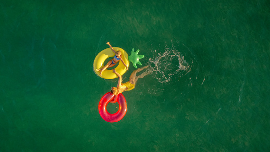Photo of mother and daughter on inflatable rings in the sea