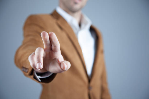 istock man touching in screen on gray wall background 1194490342