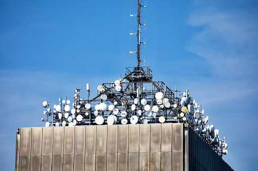 Many satellite dishes and communication antennas