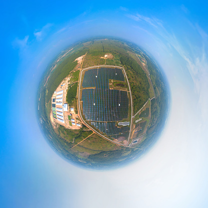 Little planet 360 degree sphere. Panorama of aerial view of solar panels or solar cells on the roof in farm. Power plant with green field, renewable energy source in Thailand.