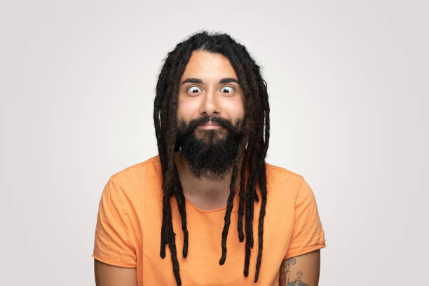 istock Young handsome bearded man hippie with dreadlocks making funny face over white background 1194491836