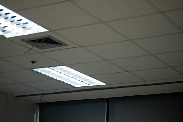 istock Fluorescent lamp Lights from ceiling in office building 1194492589