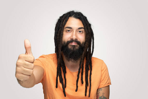 istock Confident handsome young man showing thumbs up over white background 1194493837