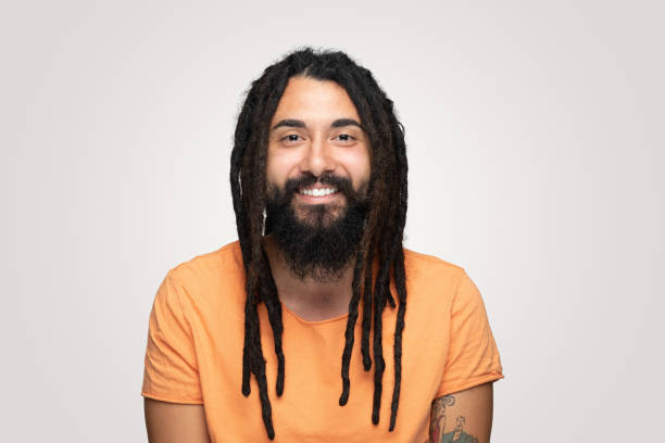 istock Laughing young handsome bearded man hippie with dreadlocks over isolated  gray background 1194493996
