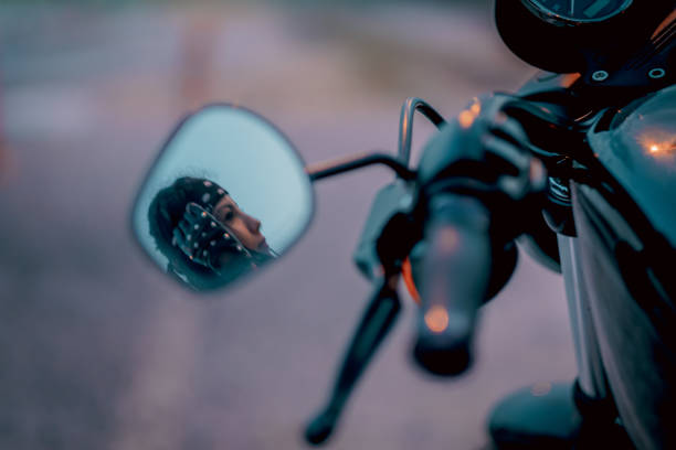 istock reflection of a biker girl from side mirror 1194495578
