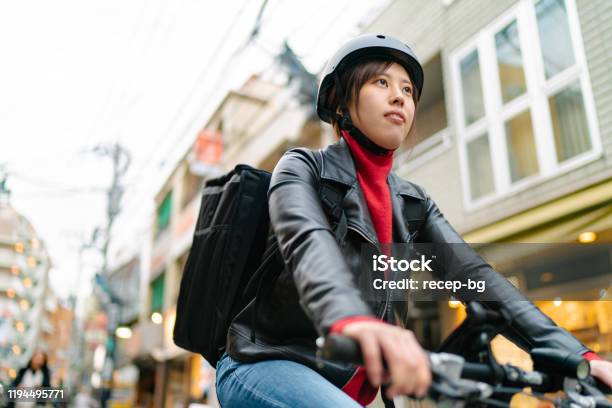 Young Woman Riding On Bicycle For Food Delivery Stock Photo - Download Image Now - Cycling, Bicycle, Part-Time Job