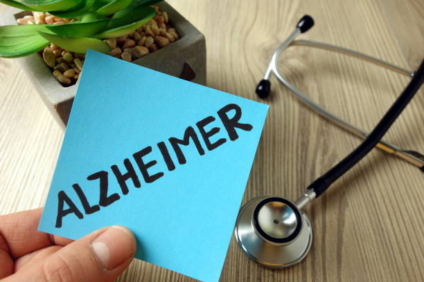 istock Alzheimer word handwritten on blue sticky note 1194497548
