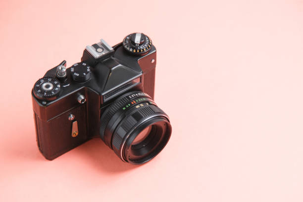 istock Retro camera on bright background. Minimalistic layout of the photographer. 1194498657